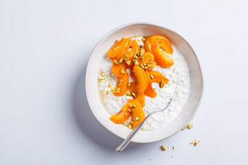 Breakfast cottage cheese with apricot, maple syrup and pistachio.