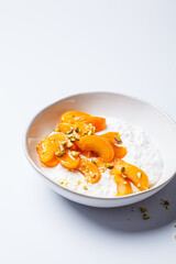 Breakfast cottage cheese with apricot, maple syrup and pistachio.