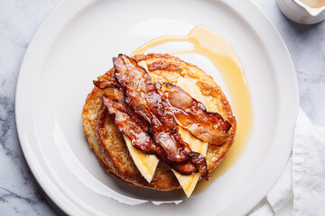 French toast with bacon, banana and maple syrup.