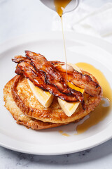 French toast with bacon, banana and maple syrup.