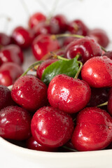 Fresh cherries in a bowl. Close-up. Selective focus. Healthy ripe summer fruit.