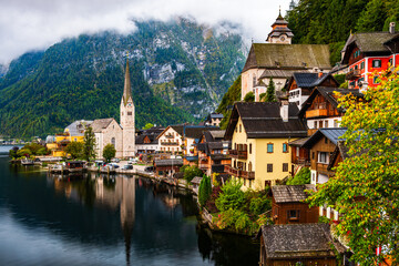 
The UNESCO world heritage site city Hallstatt by the Hallstatter See in Austria early in the blue hour dawn in misty clouds.