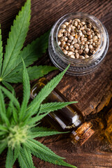 Cbd hemp oil in bottle and marijuana leaves