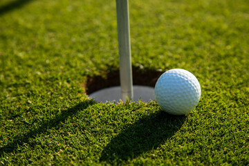 Closeup Golf ball on green grass on course