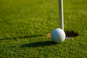 Closeup Golf ball on green grass on course