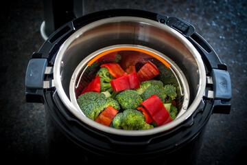fresh cooking at home - colorful vegetable cooked in a pressure cooker