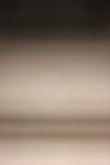 A blurry dreamy view of a gradient of brown to dark brown.