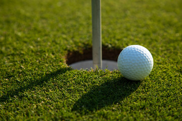 Closeup Golf ball on green grass on course