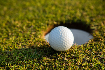 Closeup Golf ball on green grass on course