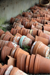 Side view of rows of old terracotta plant pots, North Yorkshire England
