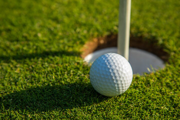 Closeup Golf ball on green grass on course