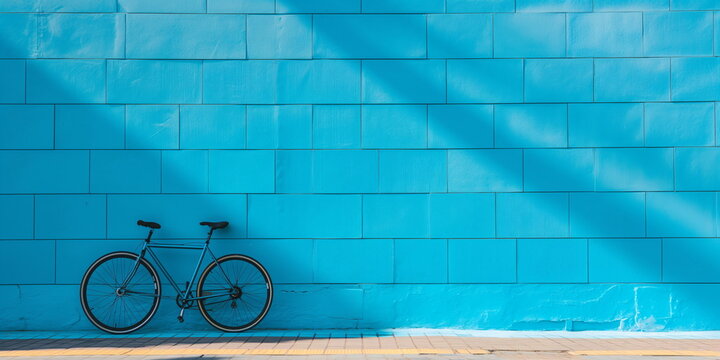 Bicycle leaning against a bright blue wall with shadow patterns