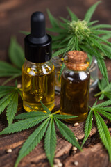 Cbd hemp oil in bottle and marijuana leaves