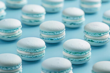 Obraz premium close up view of elegant aqua blue macarons arranged on a smooth blue surface