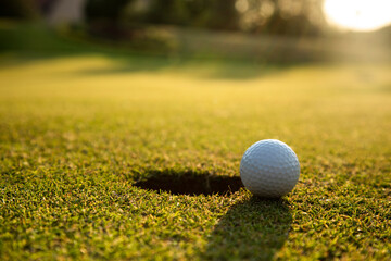 Closeup Golf ball on green grass on course
