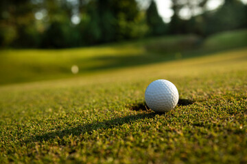 Closeup Golf ball on green grass on course