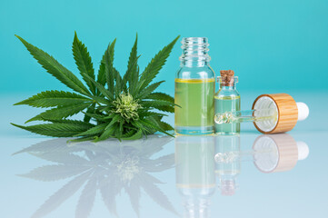 Bottles of cbd oil, marijuana and hemp leaves