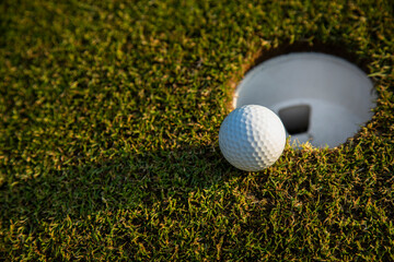 Closeup Golf ball on green grass on course
