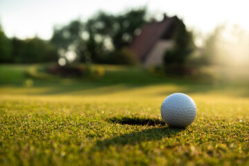 Closeup Golf ball on green grass on course
