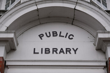 sign above entrance to traditional public library in England. Public services in UK city