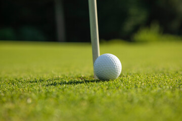 Closeup Golf ball on green grass on course