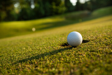 Closeup Golf ball on green grass on course