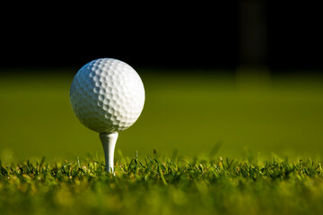 Closeup Golf ball on green grass on course