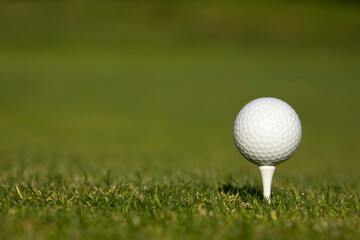 Closeup Golf ball on green grass on course