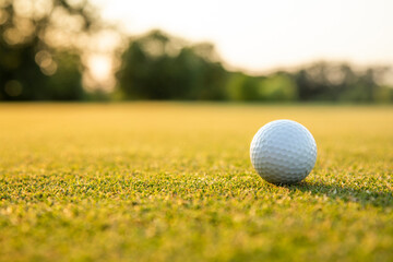 Golf ball and clubs in golf field