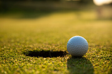 Closeup Golf ball on green grass on course