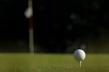 Golf ball and clubs in golf field