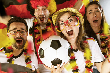 Group of enthusiastic German soccer fans celebrating the victory