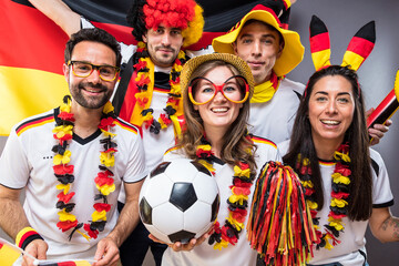 Group of enthusiastic German soccer fans celebrating the victory