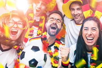 Group of enthusiastic German soccer fans celebrating the victory