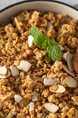 Crispy homemade granola with sliced almonds in a bowl. Healthy food