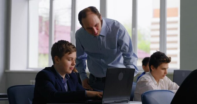 Informatics Lessons In Middle School, Teacher And Pupils In Modern Computer-Based Classroom