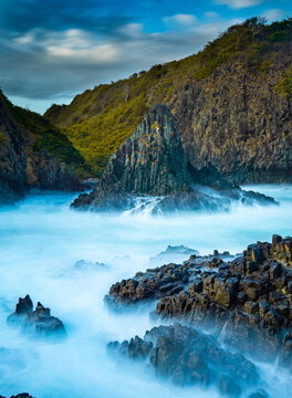 dramatic coastal scene  with rocky cliffs and waves