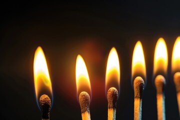 Burning Matches. Closeup of Bright Lighted Matches on Charred Black Background