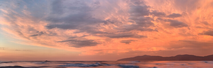 beautiful clouds in the sky over the ocean at sunset panoramic dramatic landscape