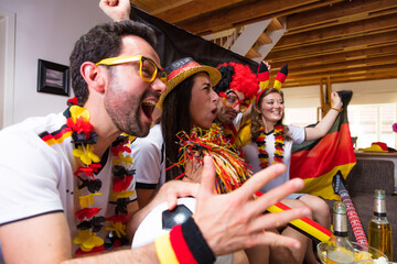 Group of enthusiastic German soccer fans celebrating the victory