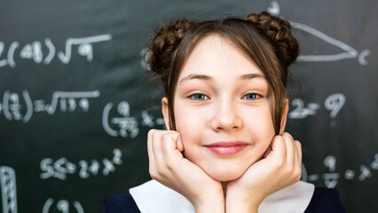 A schoolgirl girl propped her face up with her palms, a teenager put her face in her palms.