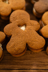 Making Festive Gingerbread Sandwiches on Rustic Wooden Table