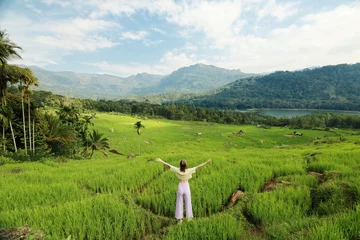 Traveling women enjoying the view of the green valley full of rice terraces, river and mountains in Kotmale, Sri Lanka