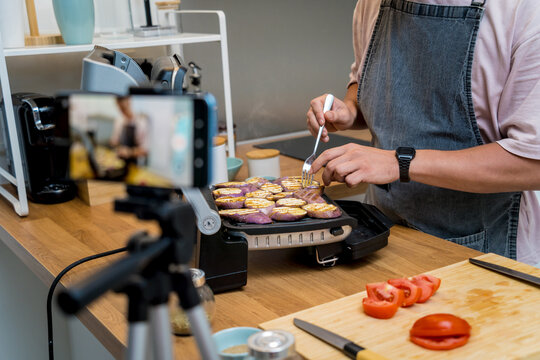 The chef is broadcasting live from workshop how to prepare a grilled eggplants with garlic