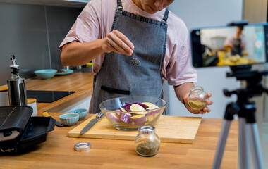 The chef is broadcasting live from workshop how to prepare a grilled eggplants with garlic