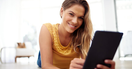 Woman, portrait and tablet on floor in living room for online shopping, e commerce and internet browsing. Girl, technology and streaming on ground in home for ebook subscription, social media and app