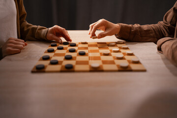 Two Friends Playing Checkers at Home, Enjoying Leisure Time, Cozy Atmosphere