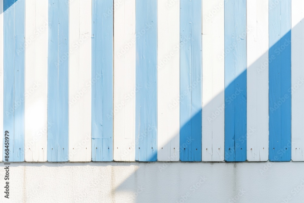 Poster bright blue and white striped pattern on sunny day crisp shadows creating depth against a simple bac