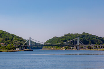 Obraz premium Wide angle view of the suspension bridge at Kanne crossing over the Albert canal, Kanne is a village in the municipality of Riemst in the southeastern part of the Belgian province of Limburg.