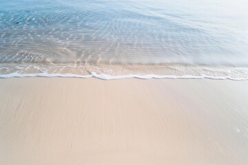 Aerial View of Sandy Beach with Intricate Wave Patterns and Footprints Highlighting Natural Beauty and Texture